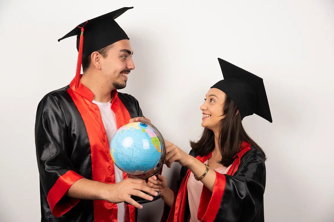 fresh graduates gown looking globe white